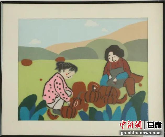 嘉峪關(guān)市新城鎮(zhèn)新城村農(nóng)業(yè)產(chǎn)業(yè)園區(qū)內(nèi)，母女兩人在摘南瓜。刺繡 馬艾米乃 繡稿 敬紅霞